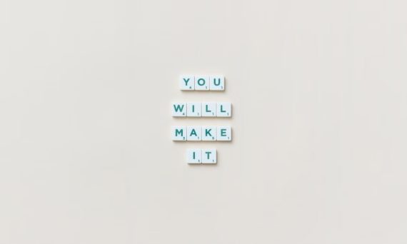 Motivational phrase 'You Will Make It' made from Scrabble tiles on a neutral background.